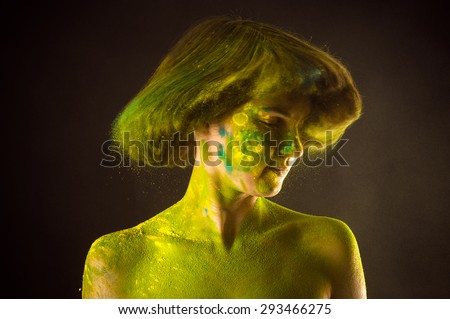 beautiful woman with frizzy hair in colors Holi