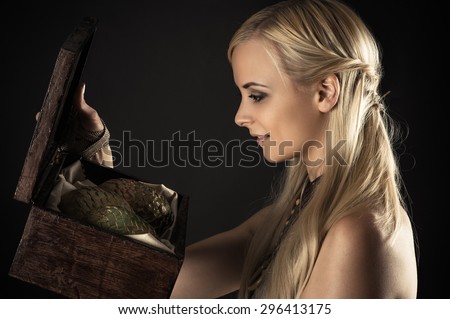 blond woman holding a box with eggs dragons