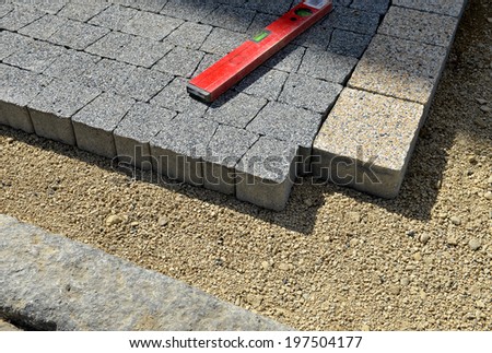 Level gauge applied at stone blocks laying