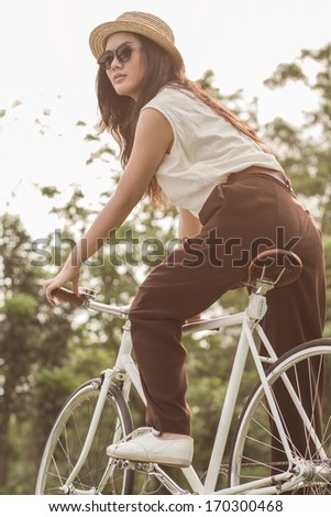 Woman sitting on her fixed gear bike.