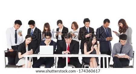 Business people using their communication devices while ignore each other in meeting