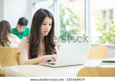 Student using a laptop in the library.