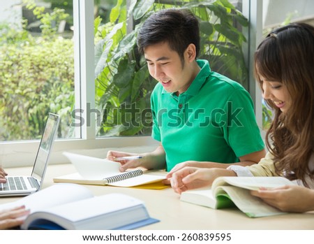 Group of Asian students studying together in the library