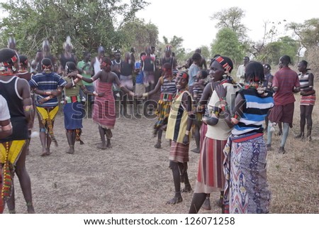 VALLEY OMO, ETHIOPIA - MARCH 12: Unidentified hamer people dance traditional dance at festival dedicated to initiation rite for young men near Dimeka village, March 12, 2012 in Omo Valley, Ethiopia.