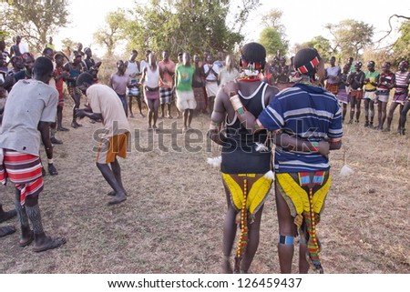 VALLEY OMO, ETHIOPIA - MARCH 12: Unidentified hamer people dance traditional dance at festival dedicated to initiation rite for young men near Dimeka village, March 12, 2012 in Omo Valley, Ethiopia.