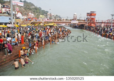 HARIDWAR, INDIA - FEBRUARY 12: Unidentified Indian people bathe in Ganga river during celebration Kumbha Mela on February 12, 2010 in Haridwar, India. Kumbha Mela is major Hindu festival in India.