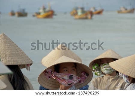 MUI NE, VIETNAM - NOVEMBER 3: Unidentified vietnamese women in traditional conical hats \