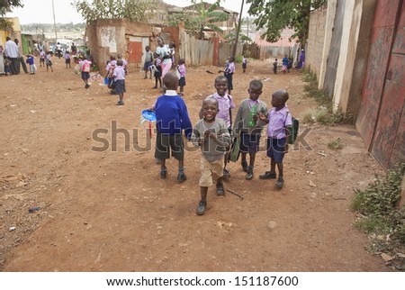 NAIROBI, KENYA - FEBRUARY 29: Unidentified school boys go home down a street of Kibera on February 29, 2012 in Kibera, Nairobi, Kenya. Kibera is the biggest slum in Africa now.