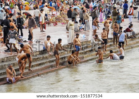 HARIDWAR, INDIA - FEBRUARY 10: Unidentified Indian people bathe in Ganga river during celebration Kumbha Mela on February 10, 2010 in Haridwar, India. Kumbha Mela is major Hindu festival in India.