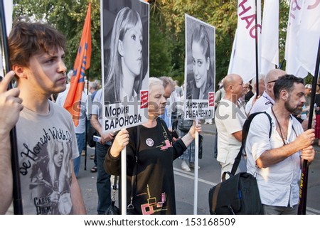 MOSCOW, RUSSIA - AUGUST 22: Unidentified people hold posters with portraits of political prisoners at meeting dedicated to Soviet Coup of 1991 ( The August Coup) in Moscow, Russia on August 22, 2013.