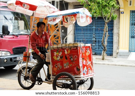CAN THO, VIETNAM - NOVEMBER 7: Unidentified street ice cream vendor waits his 	 customers on a street in Can Tho, Vietnam, November 7, 2008. Using of tricycles is common for street vendors in Vietnam.