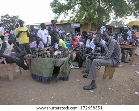 Juba, South Sudan - February 29: Unidentified Shoe Shiners Wait For Their Clients At A Market Of Juba, South Sudan On February 29, 2012. Shoeshine Is The Most Common Type Of Small Business In Juba .