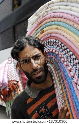 KASHMIR, INDIA - MAY 21: Unidentified street vendor sells brightly colored clothes on a Srinagar - Jammu road, India, on May 21, 2009. Traditionally, Indian Kashmir is famous for its fabrics.