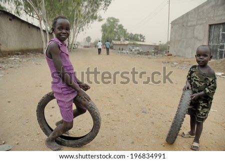 JUBA, SOUTH SUDAN - FEBRUARY 26: Unidentified kids play on a street of Juba on February 26, 2012 in Juba, South Sudan. Juba is full of refugees who live with their children in appalling conditions.