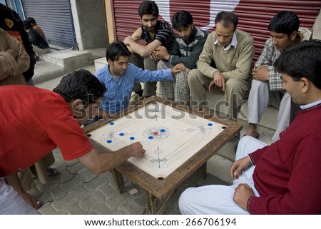 SRINAGAR, INDIA - MAY 6: Unidentified Kashmiri men play traditional board game \