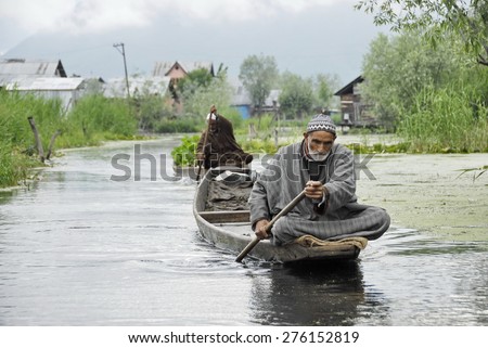 SRINAGAR, INDIA - MAY 6: Unidentified Kashmir farmers go back from a vegetable market on a water street of Srinagar, India, May 6, 2009. Using boats is common for dwellers of Srinagar.