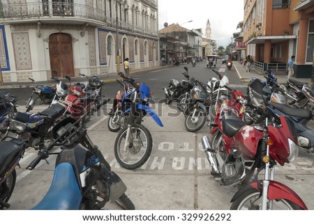IQUITOS, PERU - MAY 1: Motorbike parking on a street of Iquitos, Peru on May 1, 2010. Iquitos is inaccessible by road, so motorbike is main kind of transport here due to its cheap delivery.