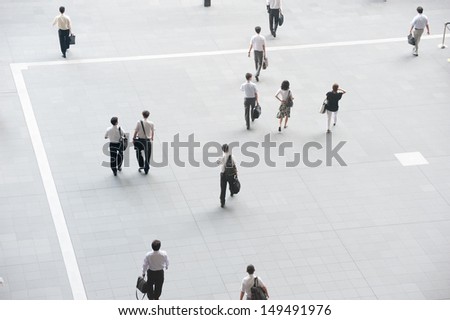 People who walk down the street with people commuting
