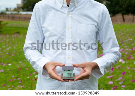 Man in white shirt that has a model of my home