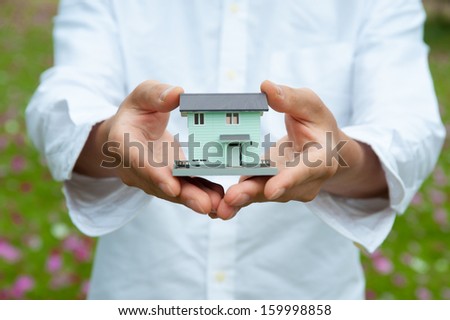 Man in white shirt that has a model of my home