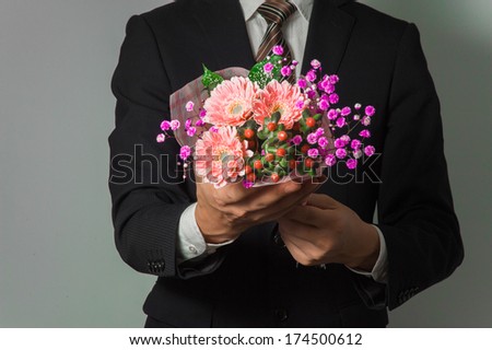 Men suit to present a bouquet of pink
