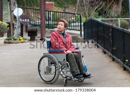 Old woman riding a wheelchair