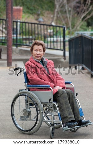 Old woman riding a wheelchair
