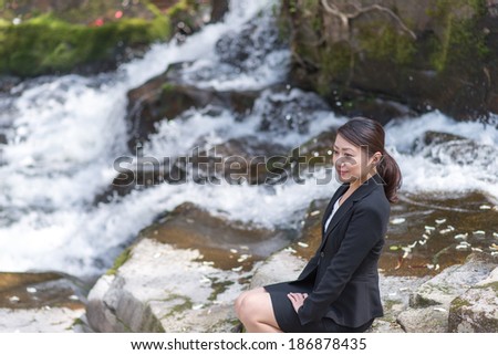 Women suit of Asia to work while relaxing in the waterfall