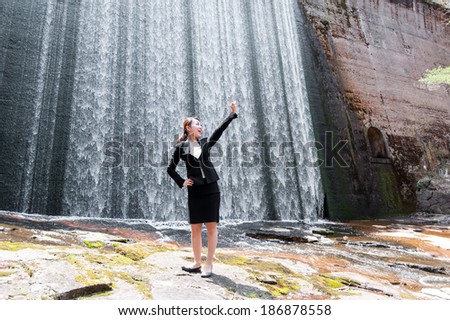 Women suit of Asia to work while relaxing in the waterfall