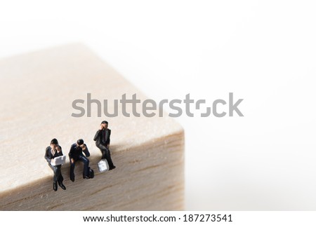 Businessmen are suffering to sit on top of the tree