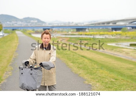 Asian elderly woman you are riding a bicycle