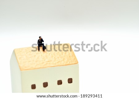 Office workers suffering to sit on the roof of the house