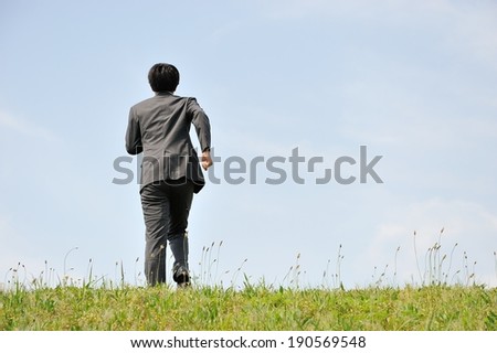 Businessmen suits walk on the prairie