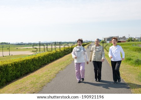 Elderly woman of Asian of three people walking down the road