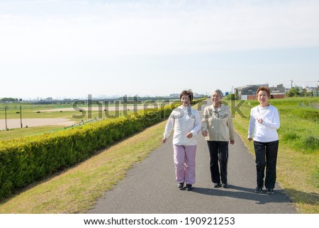 Elderly woman of Asian of three people walking down the road