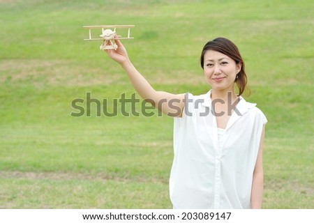 Women white shirt that has a model of airplane