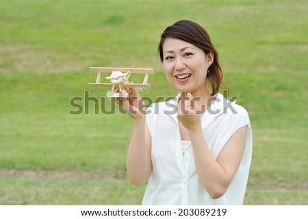Women white shirt that has a model of airplane