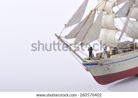 Businessman standing on top of the sailing ship