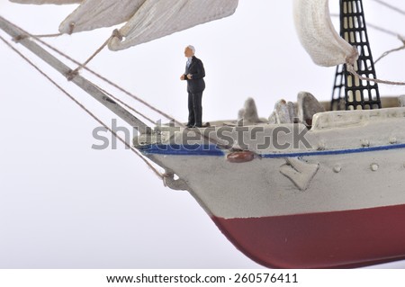 Businessman standing on top of the sailing ship