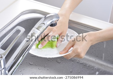 Wash the dishes in the kitchen