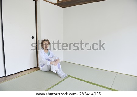 Asian elderly women who are sitting in the Japanese style of the room alone