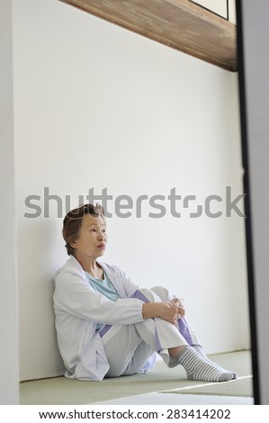 Asian elderly women who are sitting in the Japanese style of the room alone