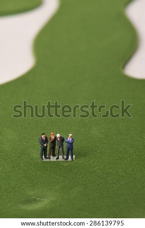 Humans have a meeting on a golf course