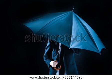 Umbrella and businessman, black background