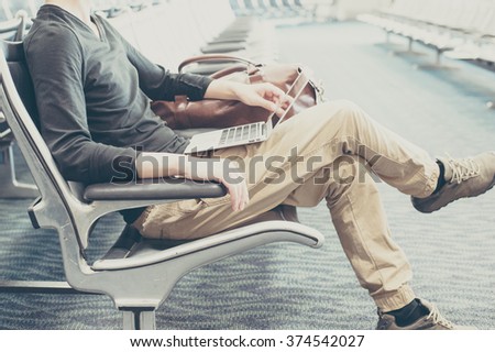 Men using a laptop in the waiting room of the airport