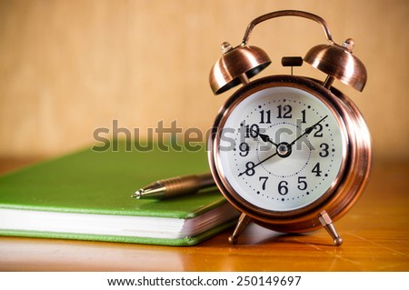 Retro alarm clock and book.