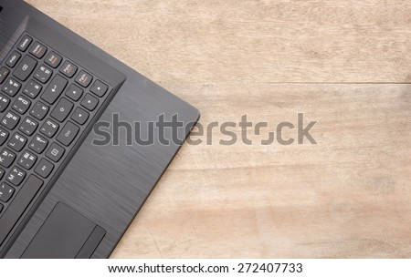Black notebook on wooden background.