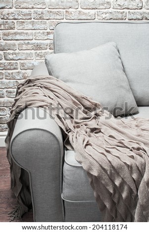 the head of the couch with a wool rug