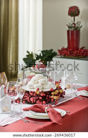 decorated table decorated with red tablecloth for the holidays with a candle and marshmallows