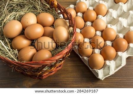 brown chicken eggs in a basket and tray storage